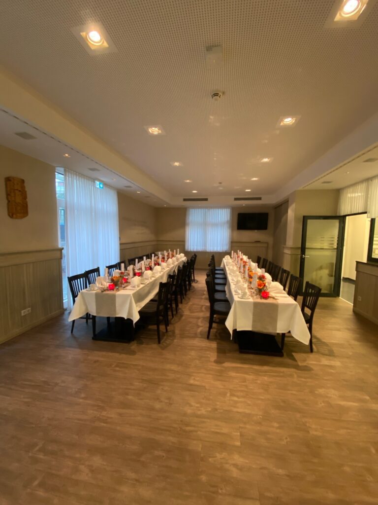 Elegant dining room with festively laid tables.